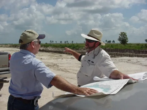 Kenny Zwahr consulting with a client at a new lake construction site