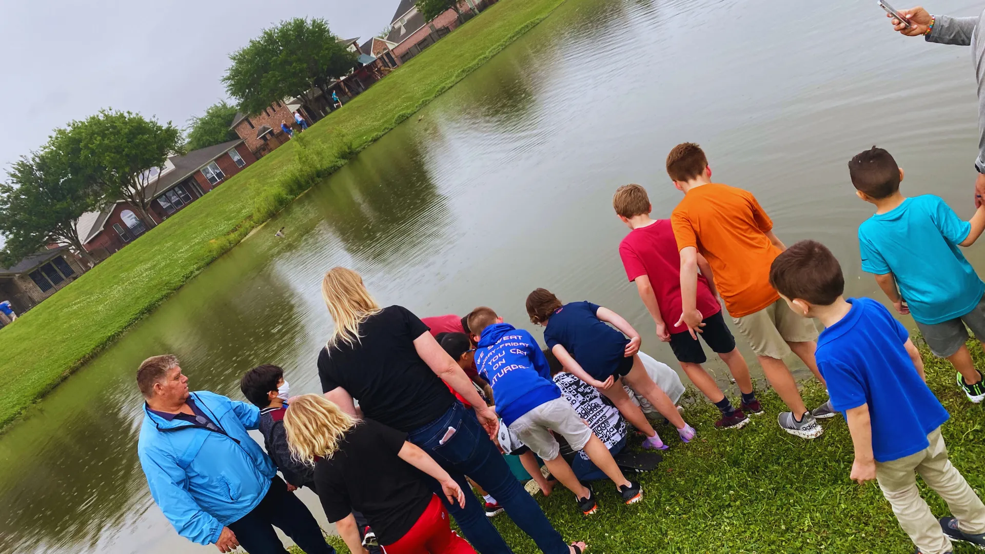 Kids helping with release of fish at neighborhood pond fish delivery