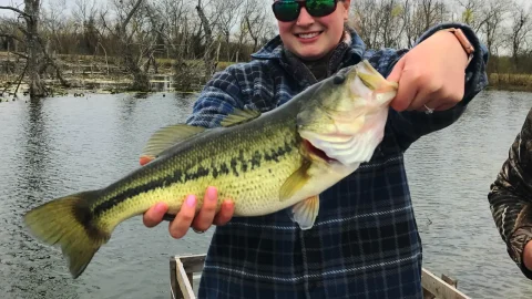 Woman holding largemouth bass